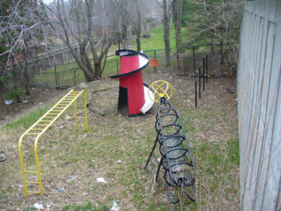 Backyard with Playground Equipment Before Junk Removal